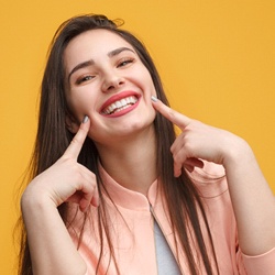 woman pointing to her teeth