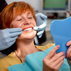 A woman examining her teeth.