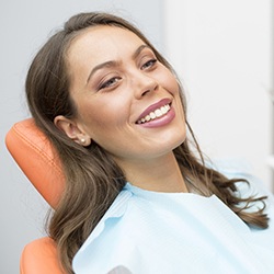 Female patient in dental chair smiling