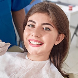 Woman in dental chair with healthy smile