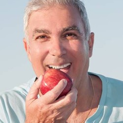 Man biting apple