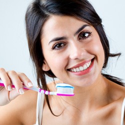 closeup of woman brushing teeth 
