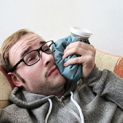 man holding ice pack to his face