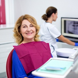 Woman with brown hair smiling in dental chair