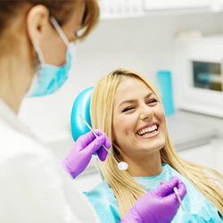 Laughing woman in dental exam chair