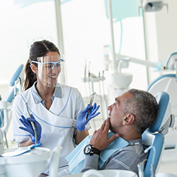 A patient discussing treatment with a dentist.