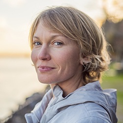 Older woman smiling at sunset