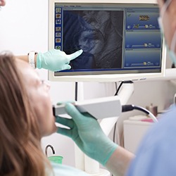 Dentist and patient looking at teeth on computer